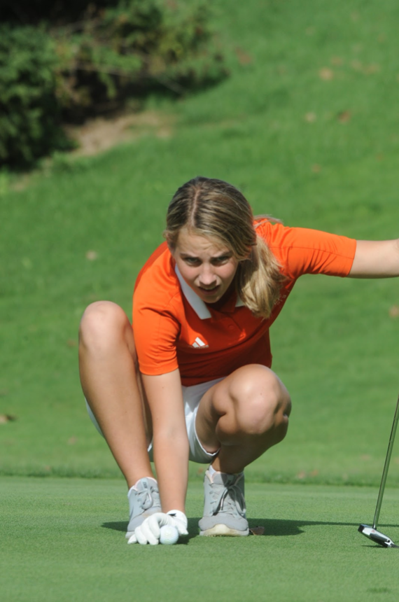 Senior+Kelsey+Montgomery+lines+up+her+ball+on+the+green+to+put+against+Livonia+Franklin+during+a+forfeited+match+on+September+24th+at+Dearborn+Hills+Golf+Course.+This+was+the+fifth+match+that+the+team+had+to+forfeit+in+the+season%2C+followed+by+another+one.