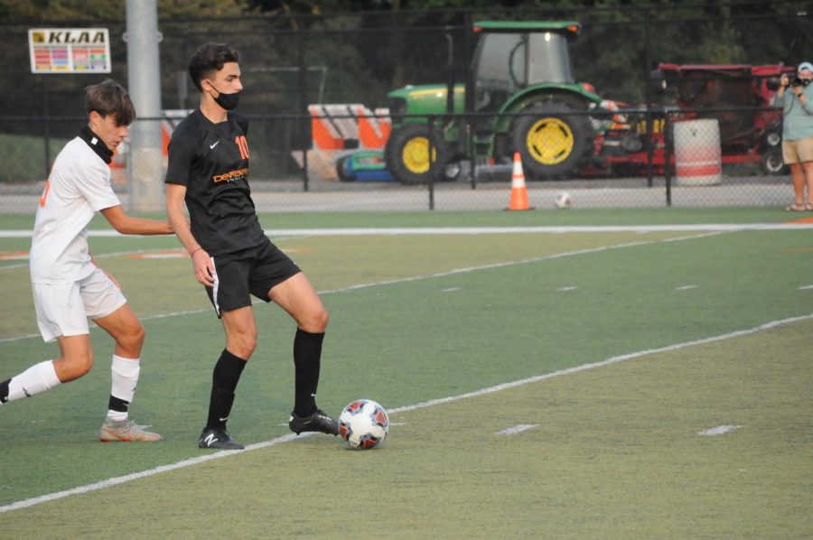 Senior Hadi Jawad tries to get by a Belleville defender. Jawad scored two goals in the game to help the Pioneers secure the 9-1 victory.