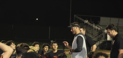 Alex Grignon talks to his team during the homecoming game against Wayne Memorial HS. The Pioneers have a playoff game Friday, Oct. 29, 2021 against Brownstown Woodhaven.