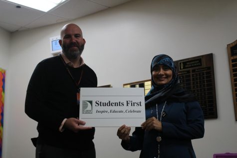 Newly appointed Executive Director of Student Achievement, Adam Martin, passes down the Student First legacy to Zeina Jebril, new head principal of DHS.