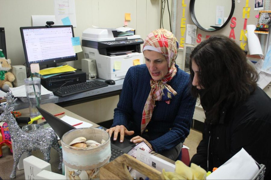 Fatme Houry showing DHS freshman Yara Hamam her grades on March 3, 2022. Hamam says she favors Houry’s teaching style. “I like the way she teaches us,” Hamam said. “It really helps me understand on what she’s teaching us.”