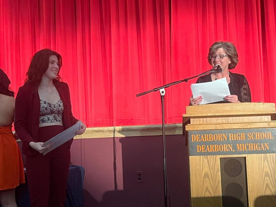 DHS senior Savannah Capote eagerly accepts her Womens Ensemble letter as well as her 1st Division Rating award from the MSVMA District Choral Festival on May 24, 2023, inside the DHS auditorium from DHS Womens Ensemble teacher Jennifer Pegouske.