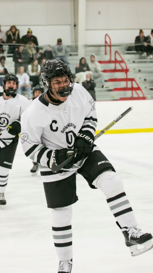 Ty Cornett celebrates after scoring a goal against SMCC High School during a hockey game